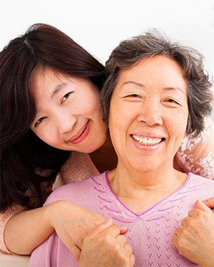Daughter hugging mom smiling