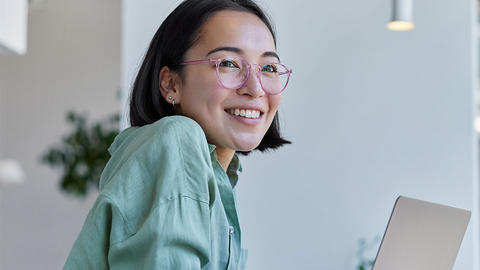 Woman smiling while on her computer