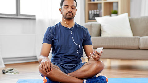 Man meditating in his livingroom