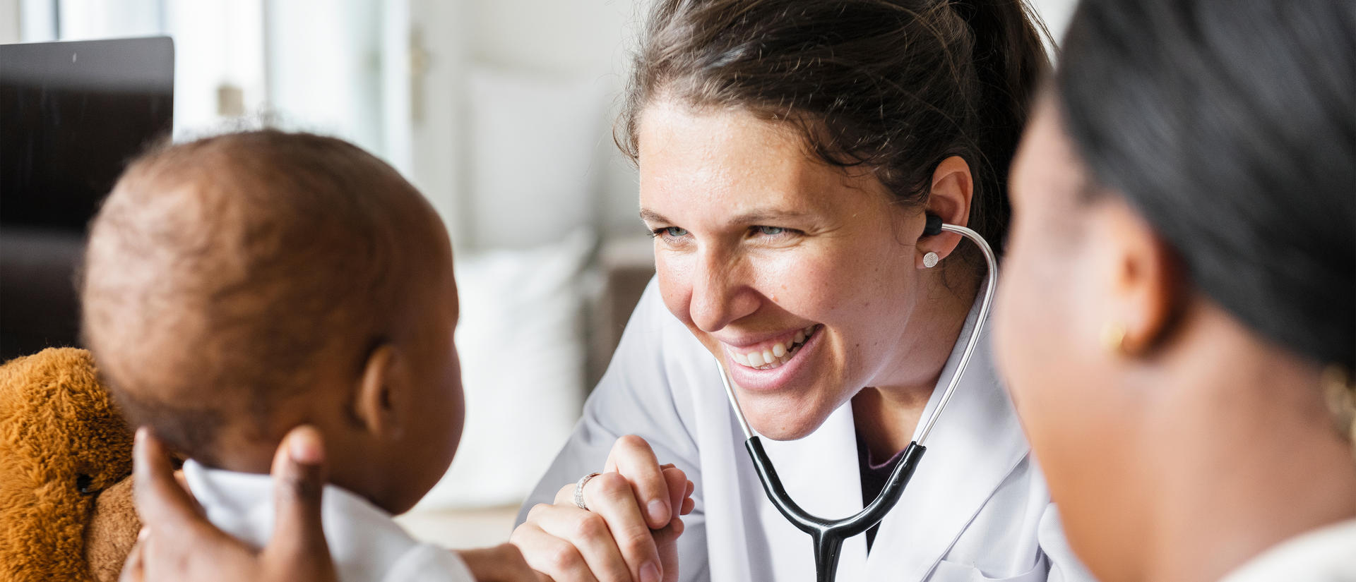 Doctor smiling at her baby patient