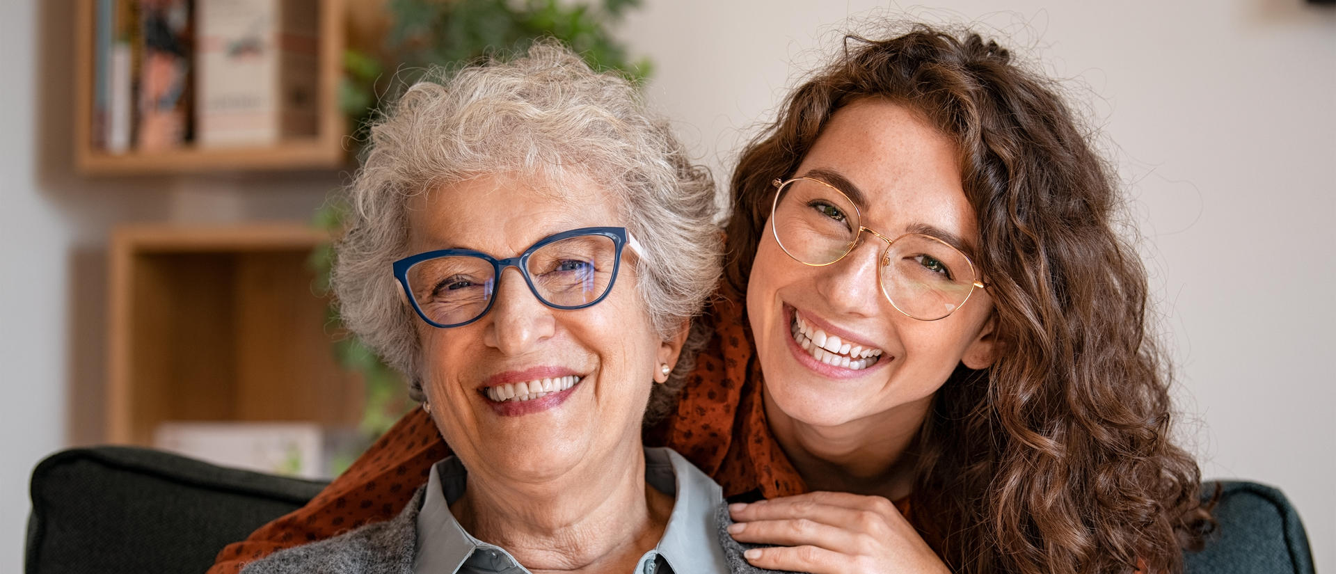 Woman with her arms around older adult
