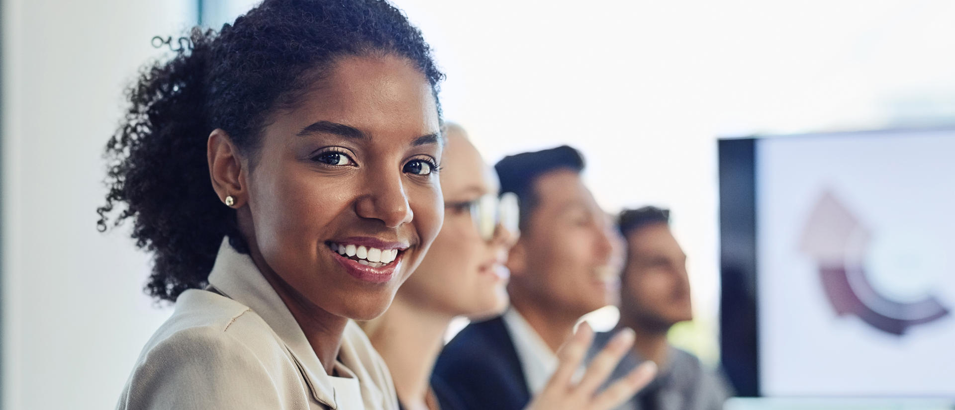 Woman smiling while in training with other colleagues